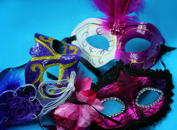 istock Three bright carnival masks on a blue background close-up 880308322