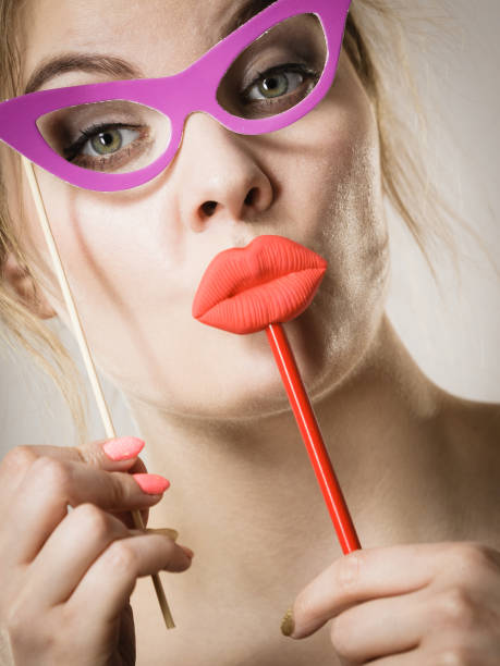 istock woman holds carnival accessories on stick 880319342