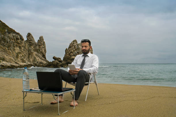istock Mobile Phone Use Businessman - Beach Working 880319388