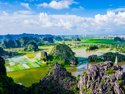 Panoramic view of karst formations and rice paddy fields in Tam Coc, Ninh Binh province, Vietnam