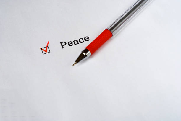 istock Checklist with inscription Peace and red pen on white paper 880322718