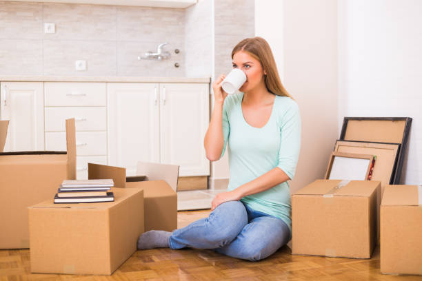 istock Woman drinking coffee  in her new home 880323176