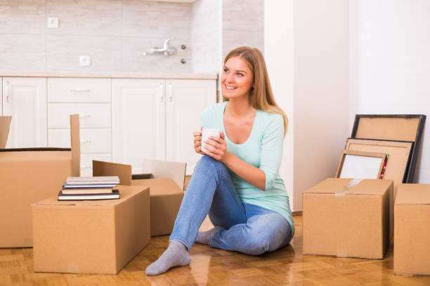 istock Woman drinking coffee  in her new home 880323428