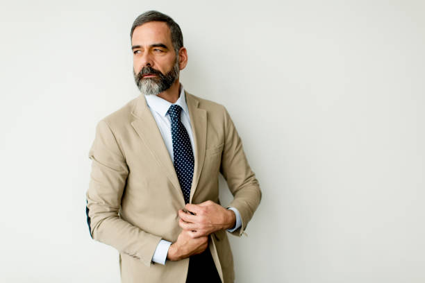 istock Bearded businessman by wall 880328898
