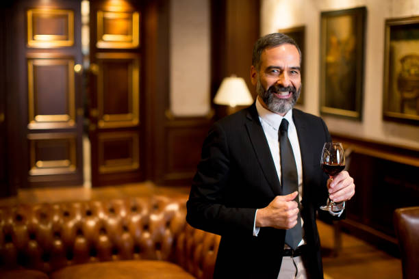 istock Handsome elegant businessman drinking red wine 880331002