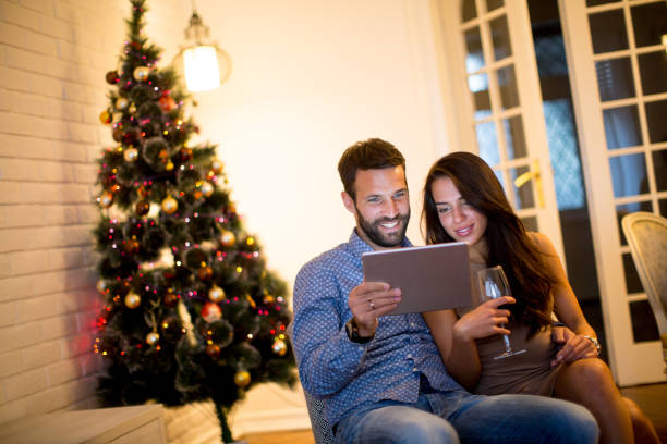 istock Young couple with tablet at New Years eve 880331186