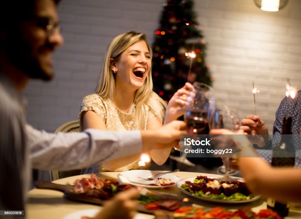 Young people celebrating New Year and drinking red wine Group of young people celebrating New Year and drinking red wine Christmas Stock Photo