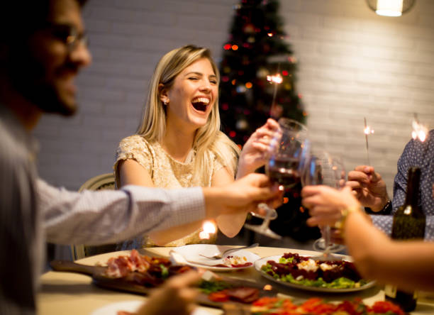 young people celebrating new year and drinking red wine - dinner friends christmas imagens e fotografias de stock