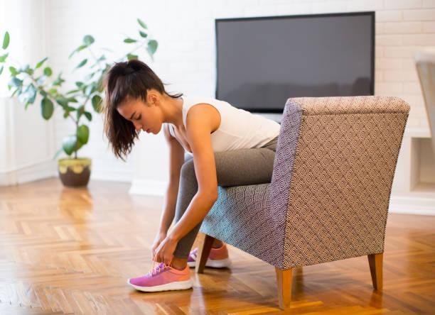 istock Young woman preparing for exercise at home 880334176