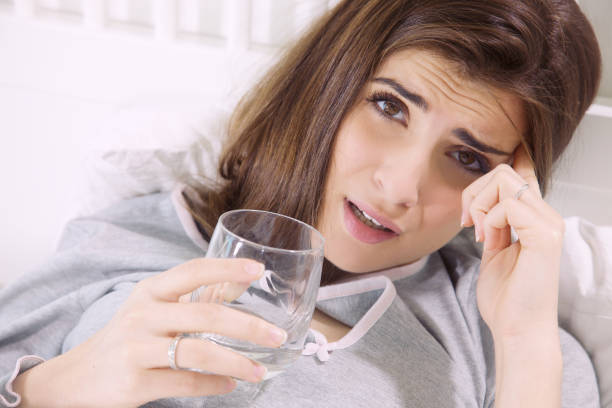 istock Woman feeling sick in bed with strong headache 880338650