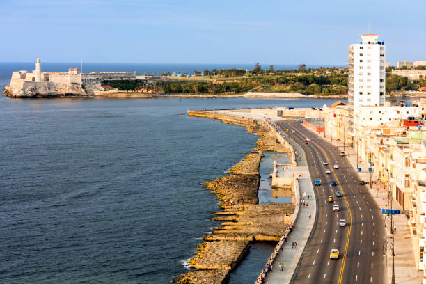 Malecon, Havana, Cuba Morning over Malecon, Morro Castle and lihthouse in the background, Havana, Cuba morro castle havana stock pictures, royalty-free photos & images