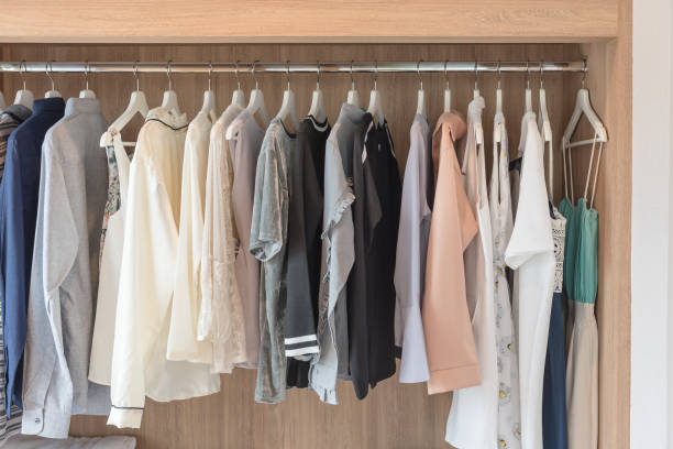 istock wooden closet with clothes hanging 880346990