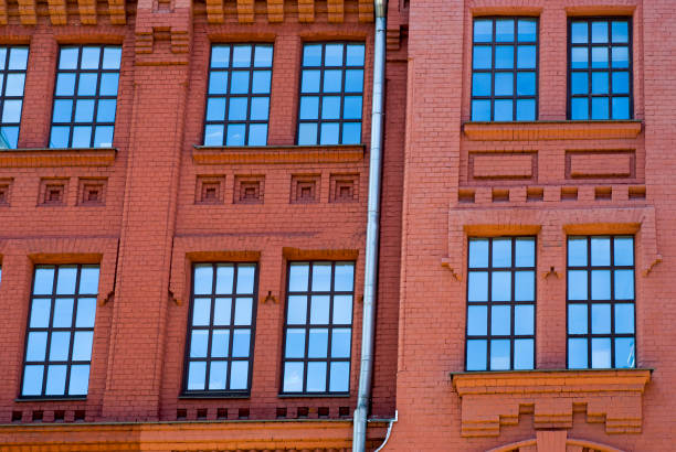 istock Industrial plant of red bricks with large windows 880353728