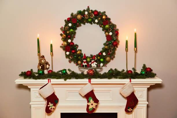 istock Christmas wreath above classical fireplace. Xmas scene. Place for text. Suitable for Christmas background. 880363470