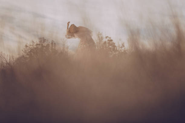 istock Hippie woman dancing in a field 880371940