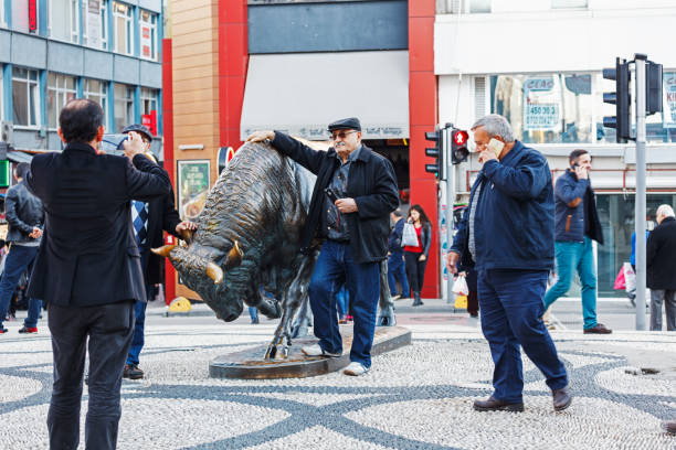 Istanbul, Turkey - November 24, 2017: People are walking next to the bull statue at the Kadikoy square. Often it is used as a meeting point in the Kadikoy, Istanbul.