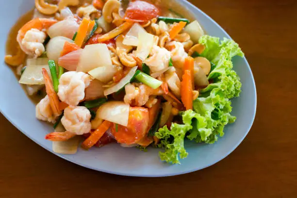 Fresh fried prawns with carrot, onion, tomatoes and cashew nuts. Traditional thai cuisine.