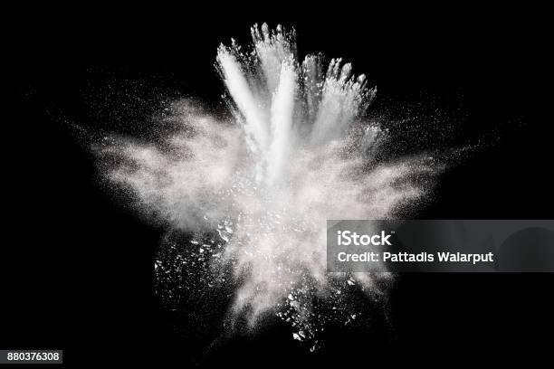 Freeze Motion Explosion Of White Dust On Black Background By Throwing Talcum Powder Out Of Hand Stopping The Movement Of White Powder On Dark Background Stock Photo - Download Image Now