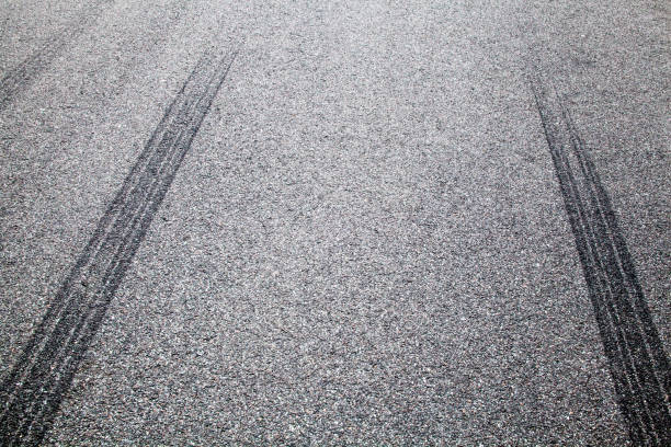 istock Wheel tracks on the road covered with hoarfrost 880376422