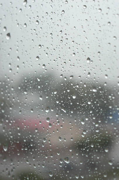 istock Drops of rain on the window, rainy day 880386052