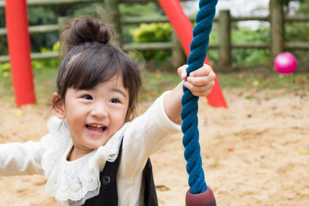 istock Girl on a Rope Swing 2 880386560