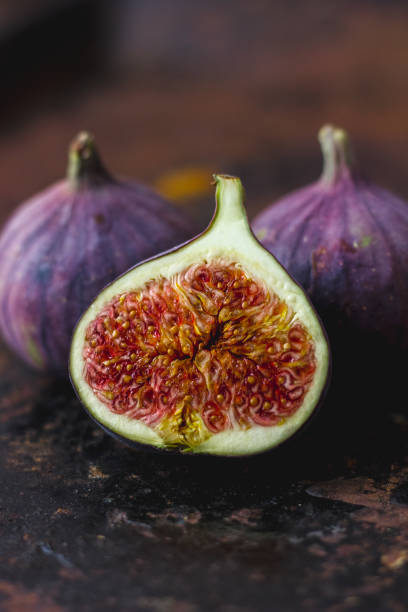 istock Beautiful and fresh figs on rusty surface. Half of fig. 880388904