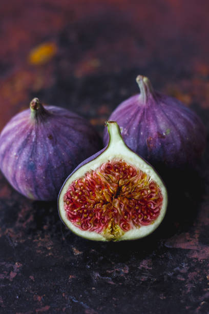 istock Beautiful and fresh figs on rusty surface. Half of fig. 880389016