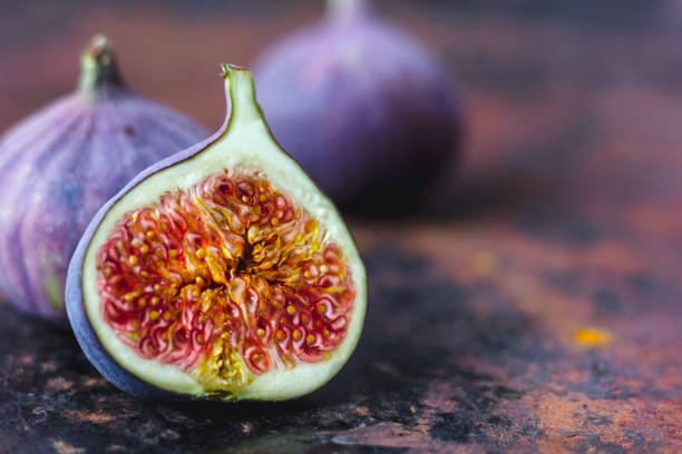 istock Beautiful and fresh figs on rusty surface. Half of fig. 880389084