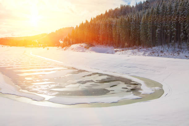 istock bright sun over frozen lake 880401076