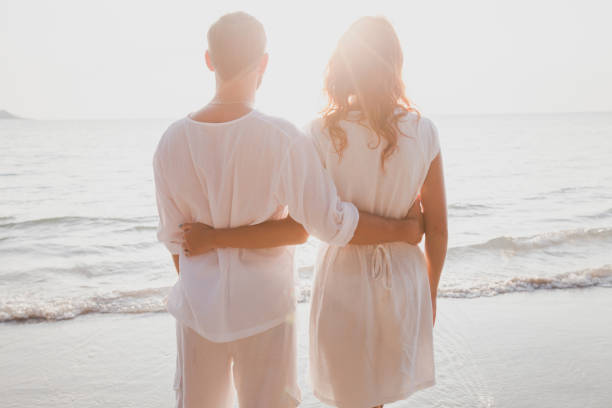 istock affectionate couple on the beach, honeymoon travel 880401092