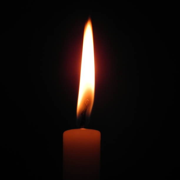istock lit candle, christmas lights 880405080