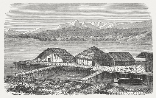 Reconstructed pile dwelling village. Wood engraving, published in 1883.