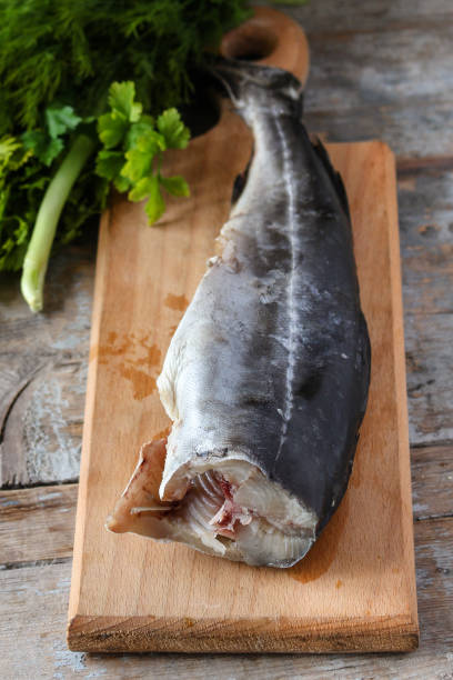 istock raw fish and greens on the kitchenette (headless) 880411110