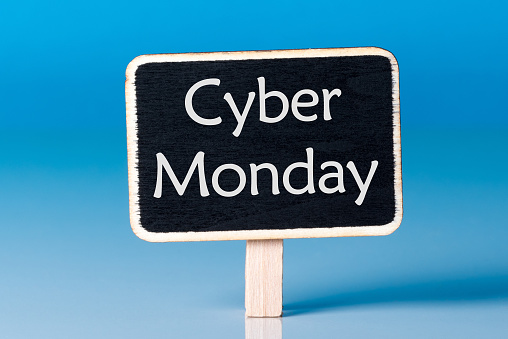 Cyber Monday shopping sale concept with little wooden tag. Sale tag close up on blue background. Best Online shopping time. Day with biggest Sale. Mockup.