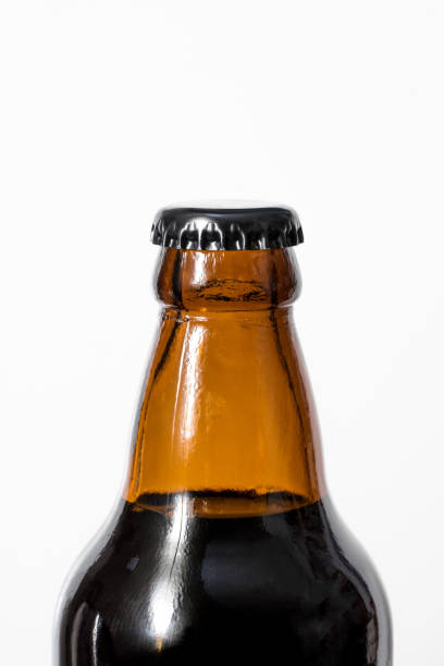 istock Brown glass bottle and black cap, white background. 880431840