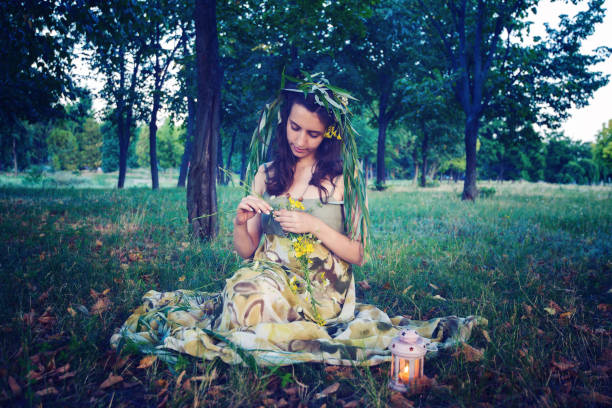 istock Lovely fairy sits on a meadow next to the lantern 880436252