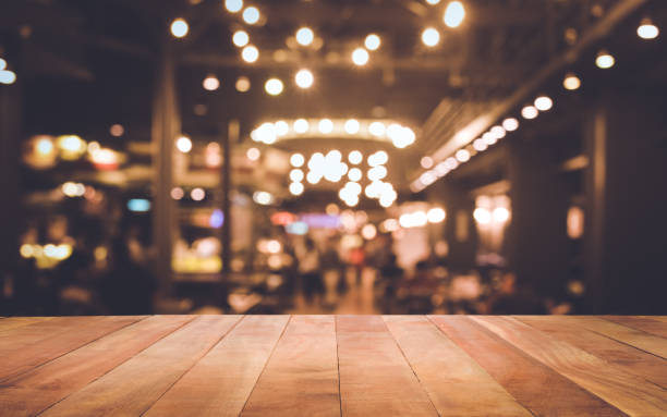 istock Wood table with blur light bokeh in dark night cafe 880436778