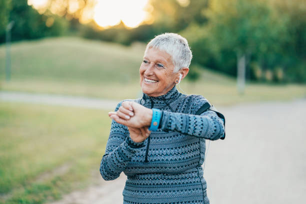 istock Senior sportswoman with smart watch 880444458