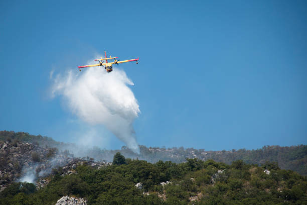 istock Airplane extinguishing the forest fire in Montenegro 880446938