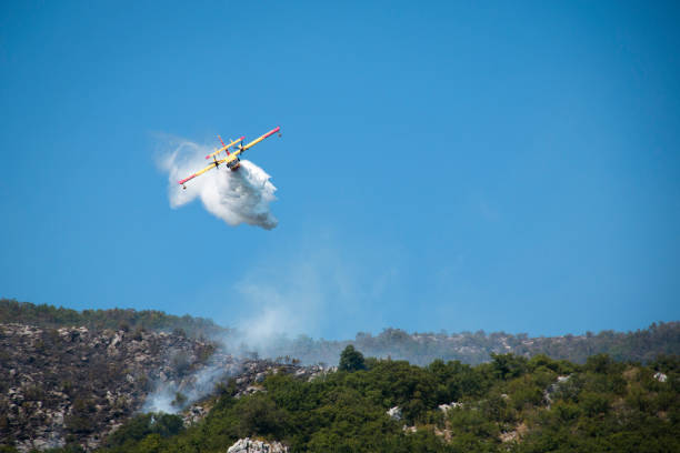 istock Airplane extinguishing the forest fire in Montenegro 880449584