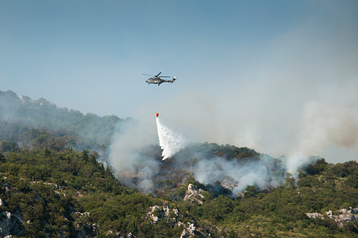 Helicopter extinguishing the huge forest fires on the mountains close to Herceg Novi and the bay of Kotor in Montenegro