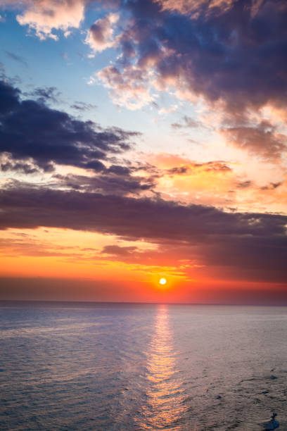 istock Beautiful dusk over calm ocean in summer with sun beam 880460430