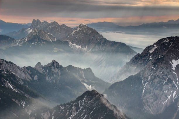 istock Mist and sun rays at dawn in Karawanken Karavanke mountains 880466618