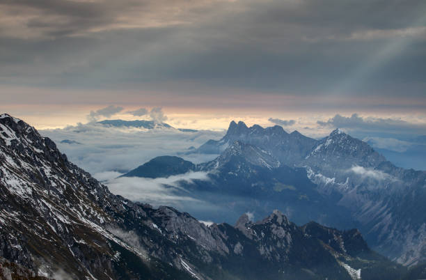 Rolling fog and sunrays at dawn, Karawanken Karavanke mountains