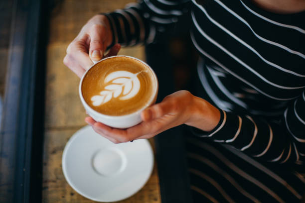 istock Lady's hands holding cup with sth heart-shaped 880466796
