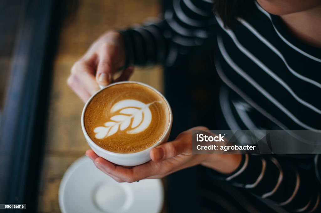 Lady's hands holding cup with sth heart-shaped Coffee - Drink Stock Photo
