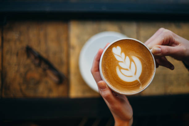 Lady's hands holding cup with sth heart-shaped
