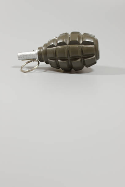istock A hand grenade in portrait orientation with copy space. 880471790