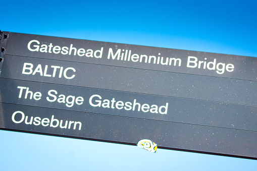 A series of direction road signs on the Quayside at Newcastle-upon-Tyne. They are for the Millennium Bridge, Baltic Art Gallery, The Sage gateshead Music Venue and Ouseburn tributary.