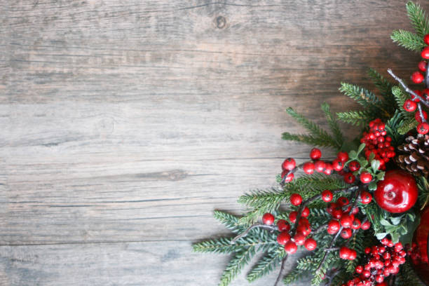 Christmas Pine Branches and Berries Background Christmas Pine Branches and Berries in Corner Over Rustic Wooden Background winter still life stock pictures, royalty-free photos & images